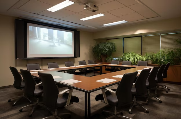 Well-maintained meeting projection room with a large screen and comfortable seating, showcasing the exceptional standards of a commercial cleaning service for collaborative environments.