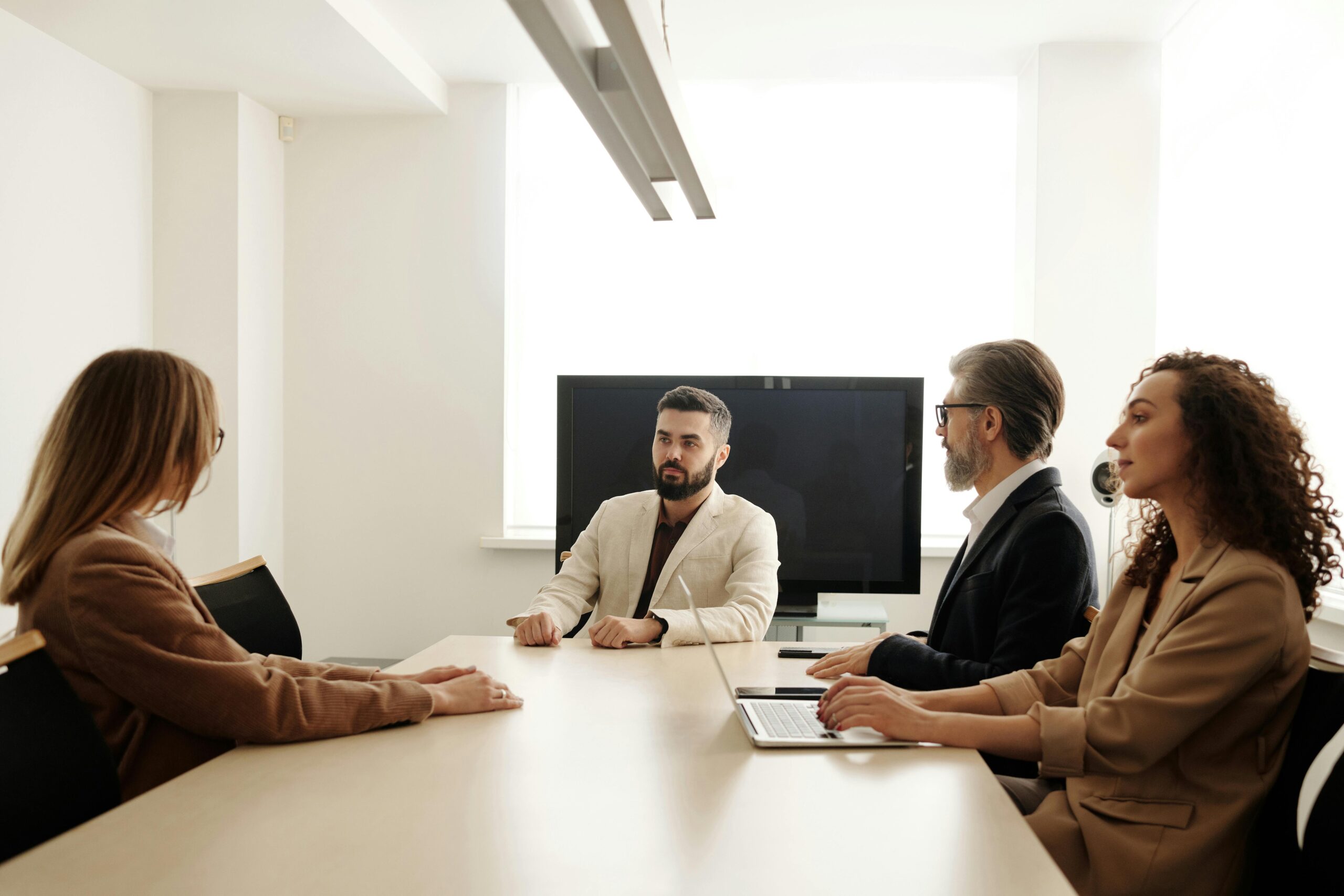 Pristine small client meeting room with comfortable chairs, exemplifying the high standards of a commercial cleaning service for professional settings.